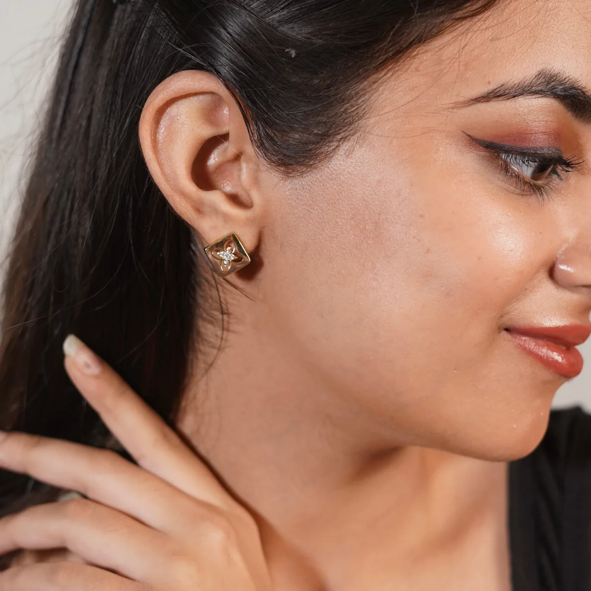 Bhavya wearing Gold Floral Cutout Square Stud Earrings